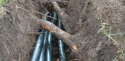 pipes under roots in trench