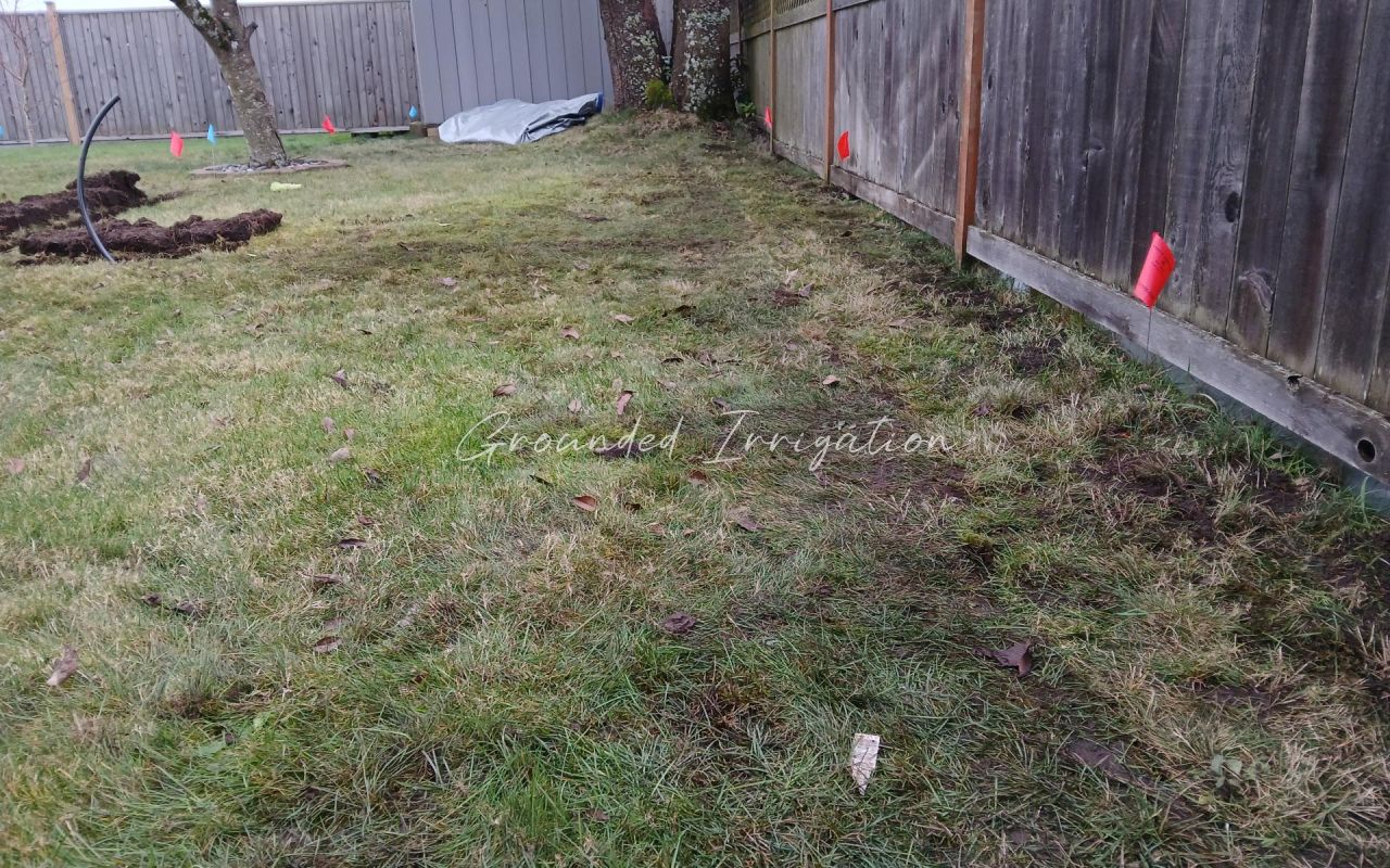 trench backfilled pipe coming out of ground
